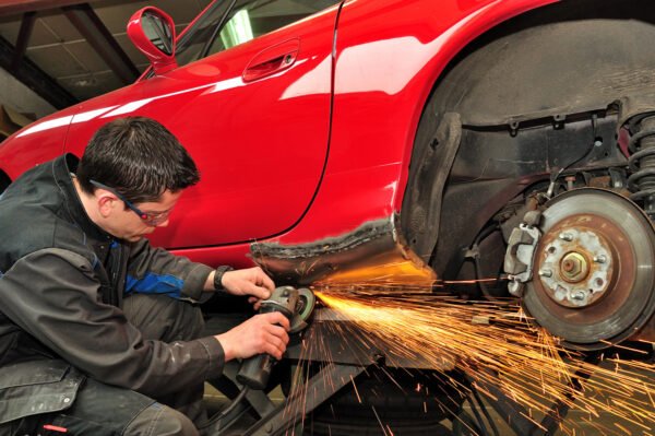 auto body shop technician repairing a vehicle