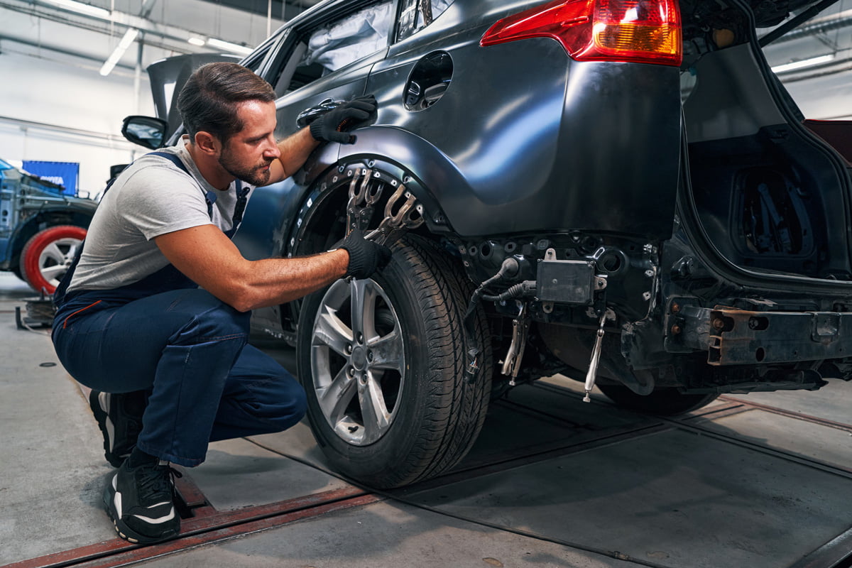 technician completing automotive body repair on car's wheel well